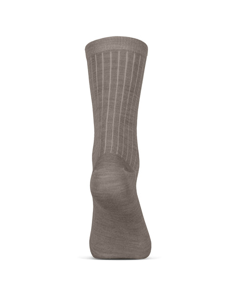A single brown, ribbed crew sock standing upright on a white background, viewed from the back. The texture of the fine knit and the ribbing running down the leg and onto the foot is clearly visible.