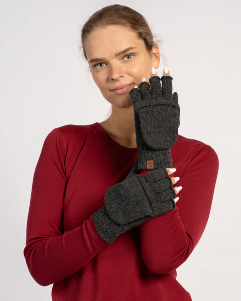 Woman wearing dark gray convertible Merino wool gloves, versatile fingerless gloves with mitten cover for warmth and style.