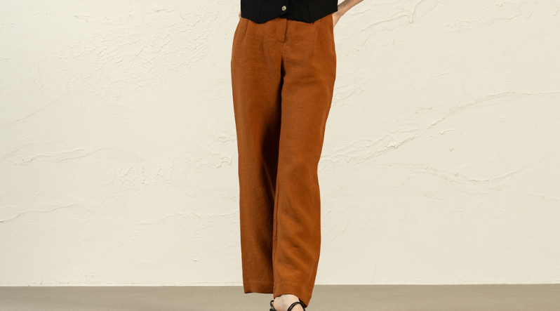 a woman wearing almond brown linen pants lotus.