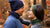 You can see a couple standing and looking at each other. Man is wearing blue color neck gaiter and beanie while woman is wearing dark green headband and neck gaiter. All these accessories are made from soft and warm 100% Merino wool.