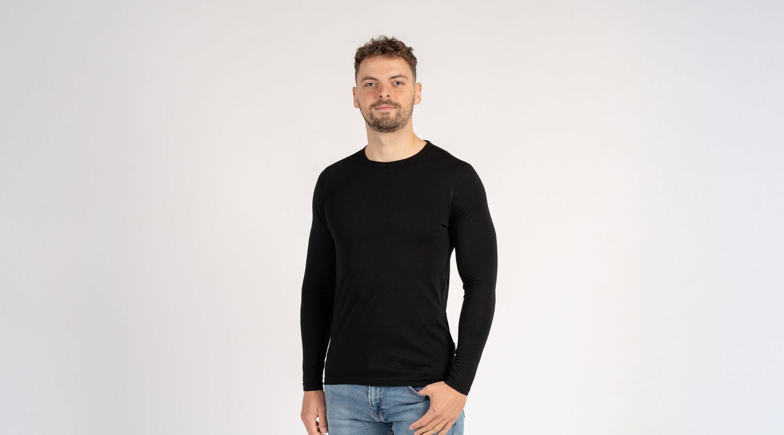 Man sitting on the sofa and wearing Merino wool long sleeve top