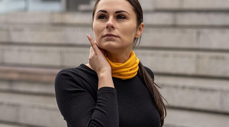 Woman wearing yellow neck gaiter from merino wool