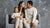 In the photo you can see a family – woman, man, and a baby – sitting on a couch, smiling. They are all wearing matching natural color loungewear/pajamas/two-piece sets made from natural 100% Merino wool.