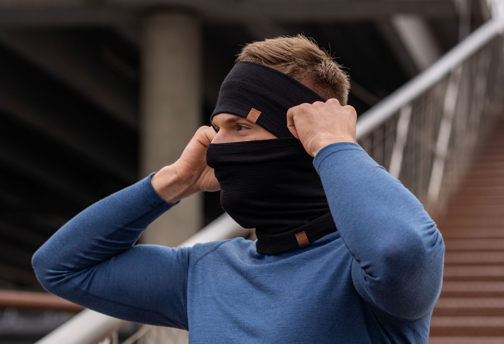 Breathable Merino wool clothing - man standing outdoors and wearing neck gaiter