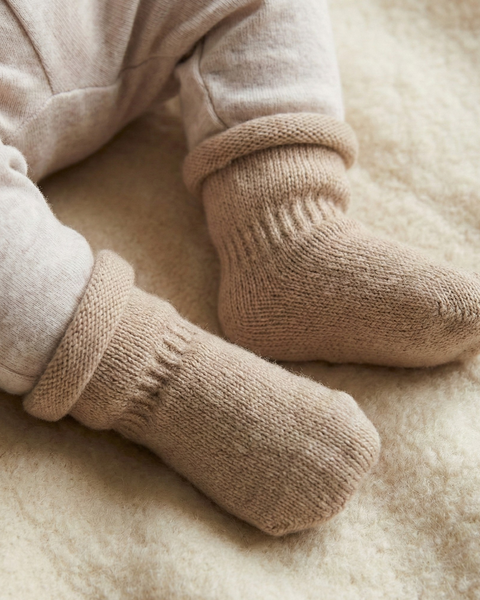 Baby merino wool socks in creamy beige, gentle temperature-regulating knit booties for newborn and toddler