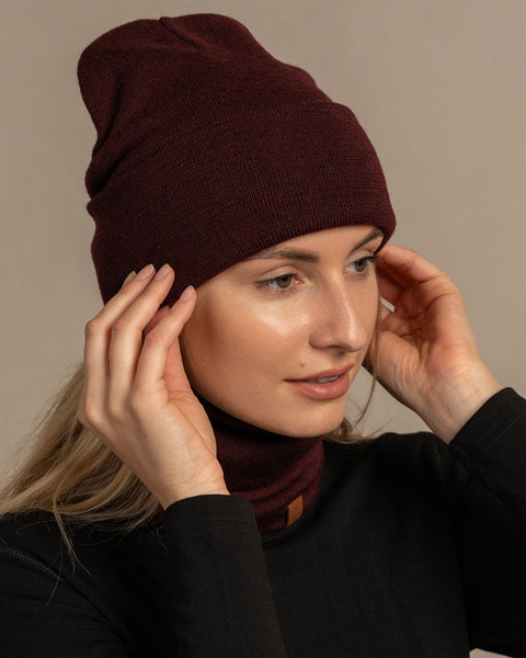 Woman wearing royal cherry knitted merino wool beanie and gaiter