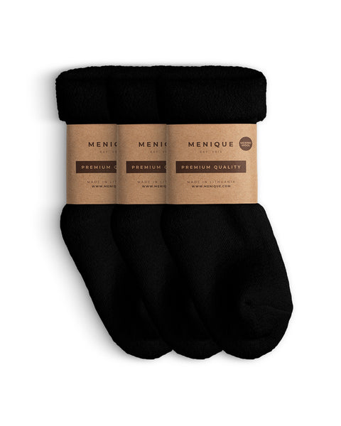 A 3-pack of kids’ black sherpa-lined merino wool socks with Menique branding.