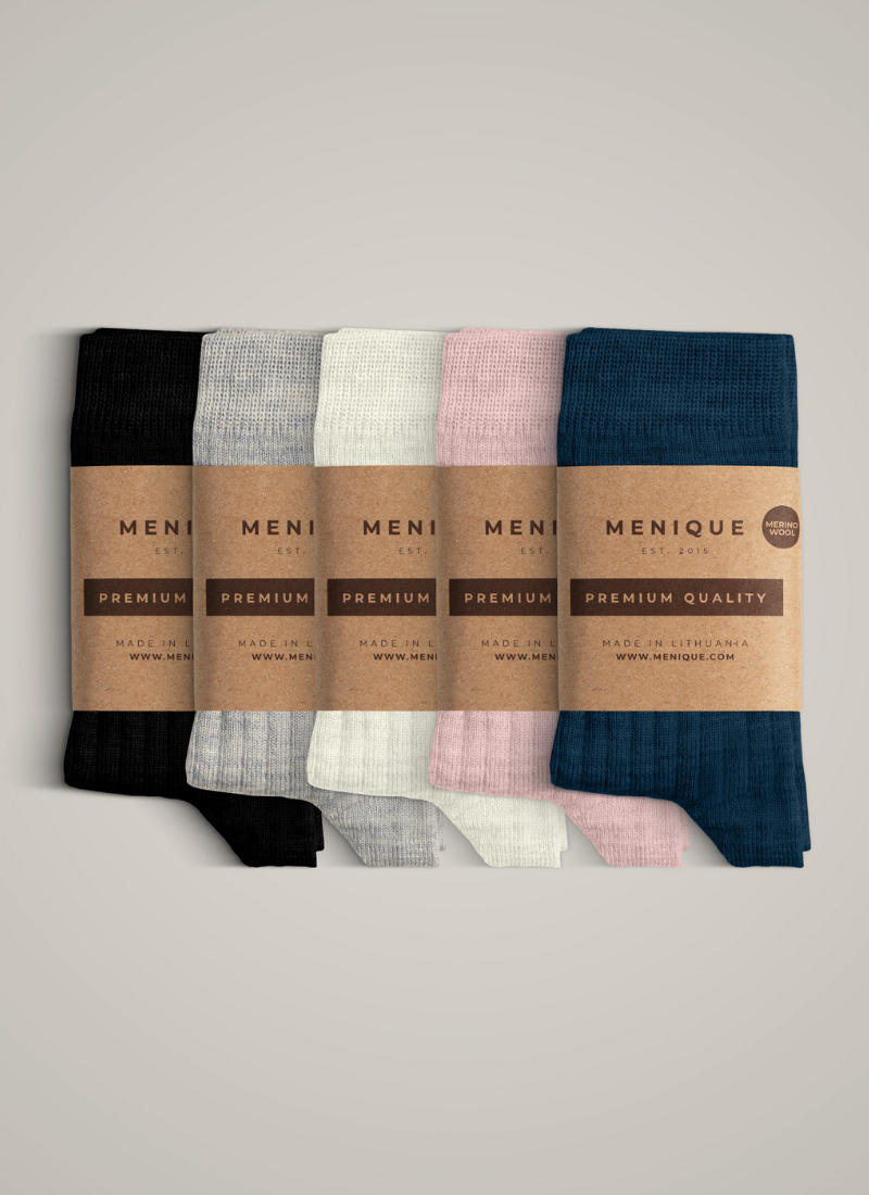 A neat stack of five pairs of ribbed knit socks displayed against a plain background. From left to right, the colors are black, light grey, cream, light pink, and navy blue. Each pair is wrapped with a brown cardboard label bearing the brand name "MENIQUE" and the words "PREMIUM QUALITY".