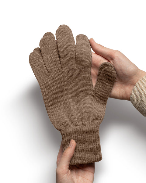 Brown Merino wool knit glove held in hands to show texture, thickness, and stretchy cuff.