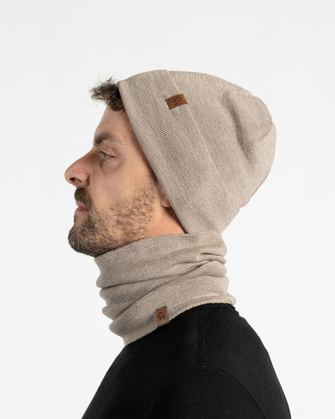 Man wearing a menique creamy beige knit beanie and scarf on a white background
