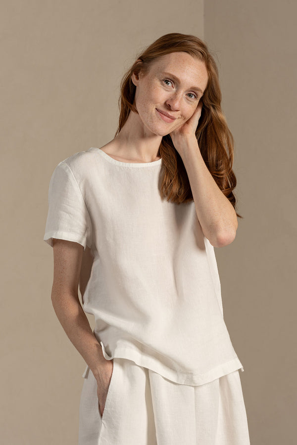 Woman wearing Linen short sleeve top Emma in Pure WHite color matched with Linen skirt Sophia
