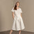 Woman wearing Linen short sleeve top Emma in Pure WHite color matched with Linen skirt Sophia