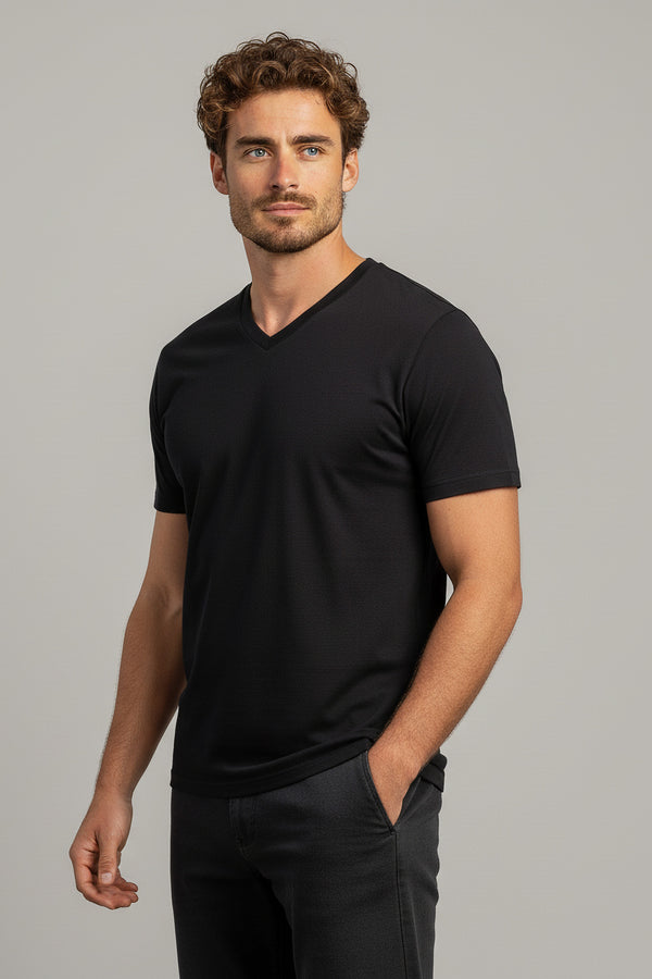 Man wearing a black t-shirt against a gray background