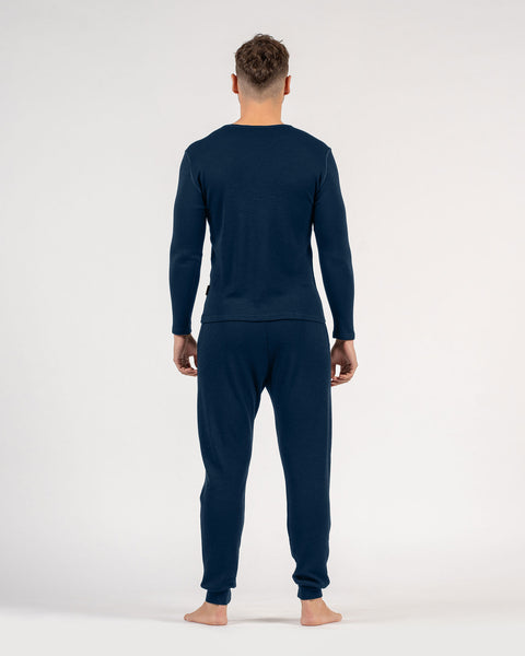 The menique men&#39;s merino wool 250gsm long sleeve top and jogger sweatpants set in dark blue color.