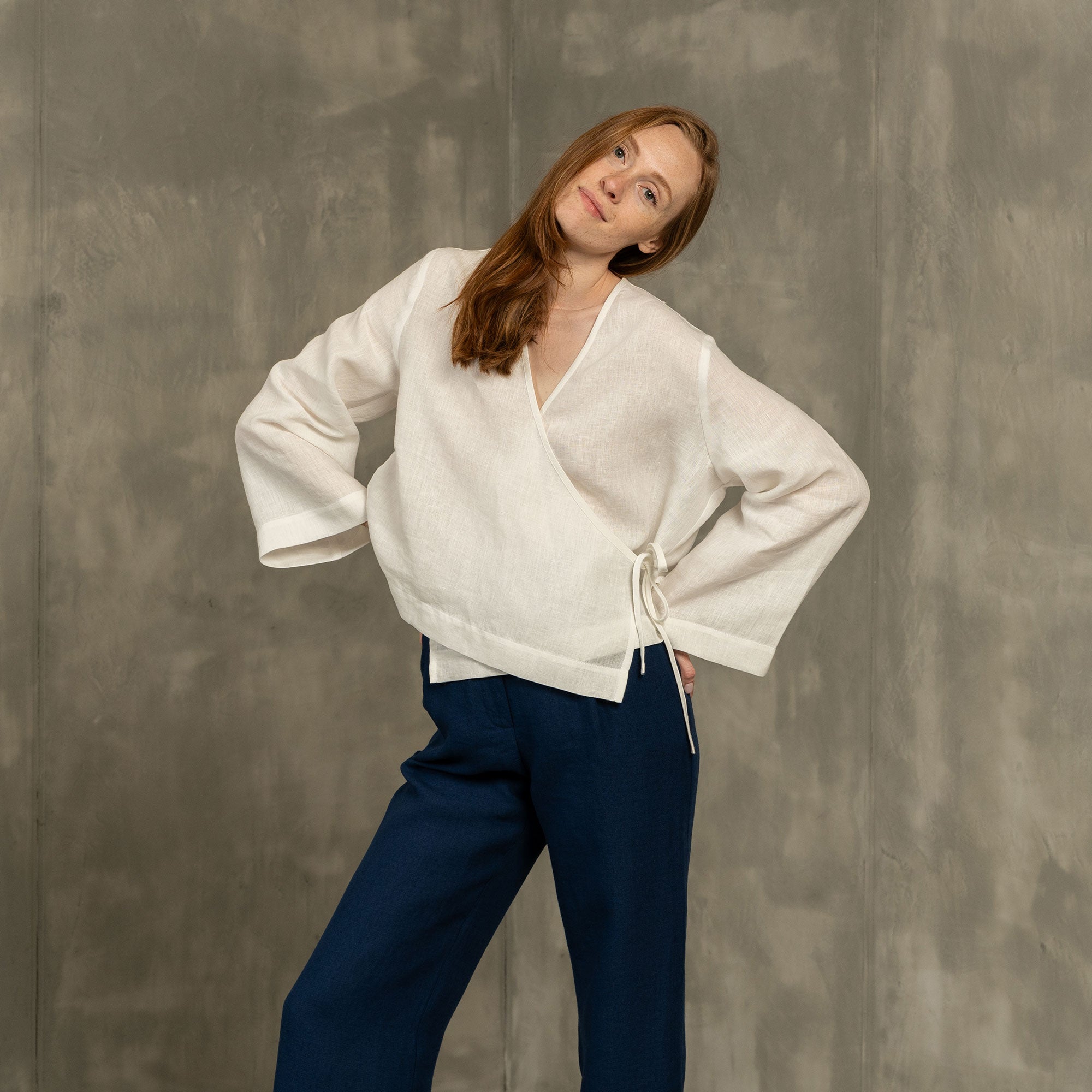 Linen wrap top Thea in Pure White color matched with Linen pleated pants Lotus in Storm Blue color