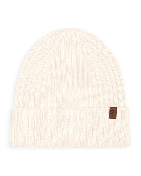 White cashmere knit beanie with a brown logo tag on a white background