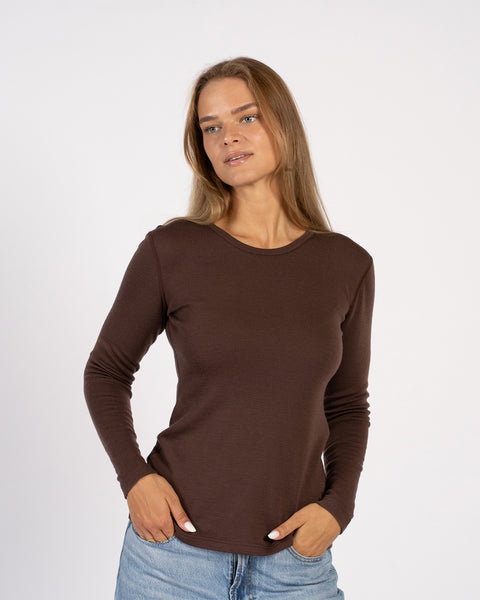 Relaxed pose in brown Merino wool thermal crew top, soft stretch fabric.