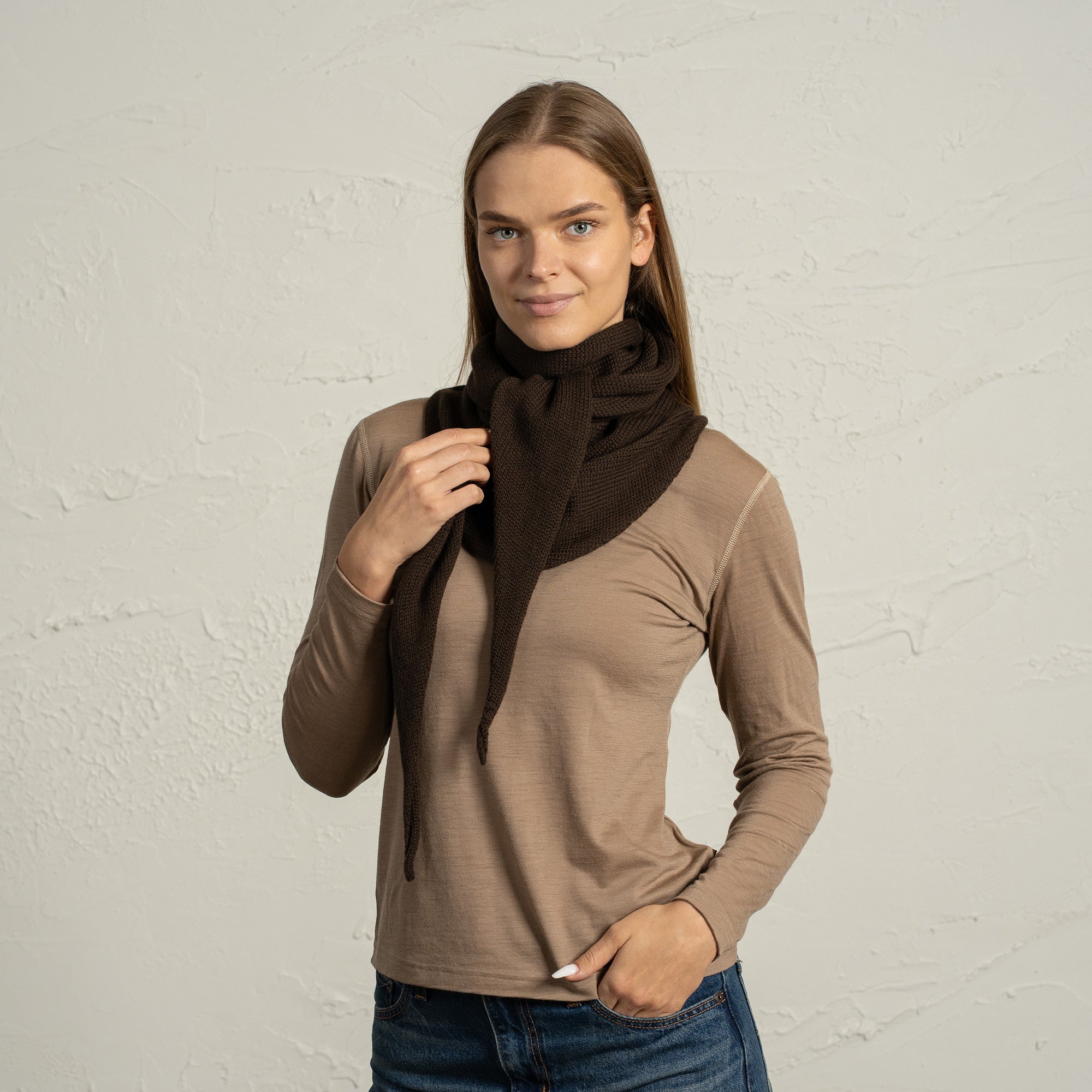 Close-up of woman wearing brown merino wool bandana styled as a hood scarf.