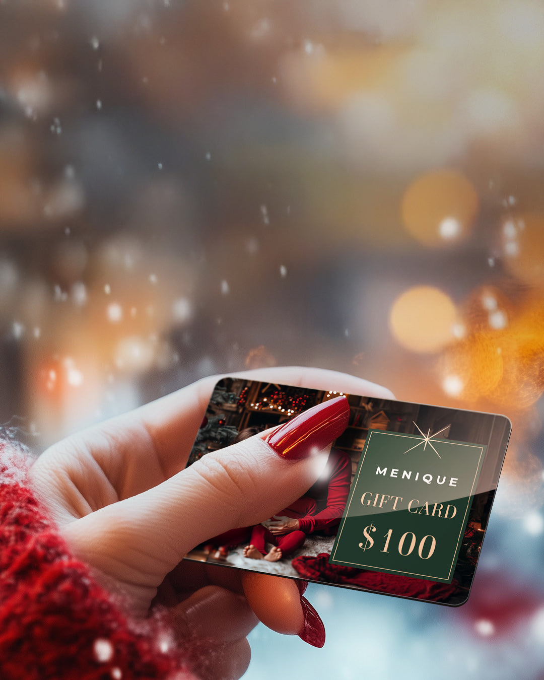 Hand holding a Menique gift card with a festive background