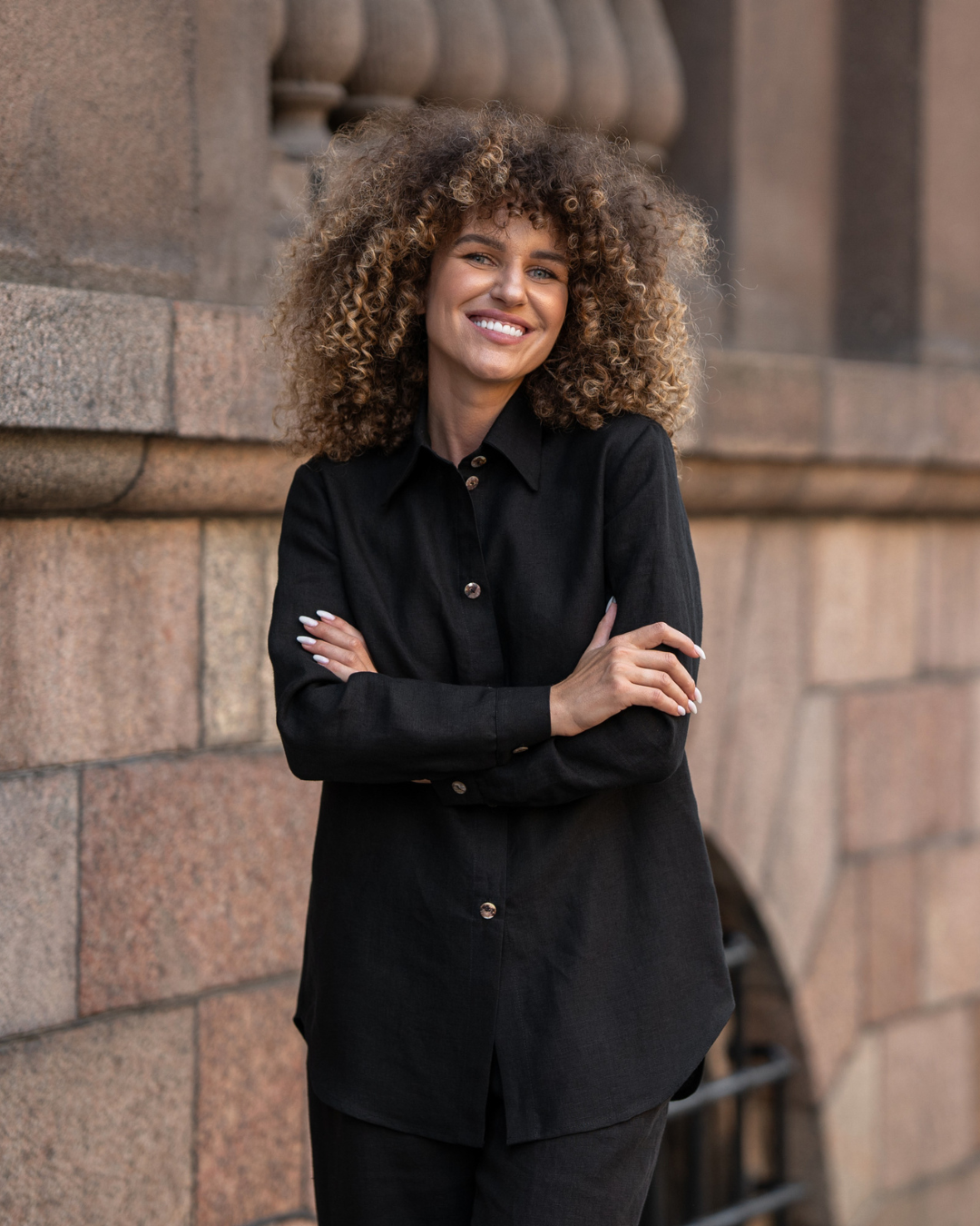 a woman wearing the menique linen black button front shirt REBECA.