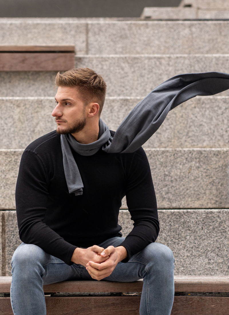Man sitting outside and wearing Merino wool scarf