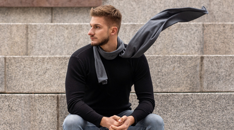 Man sitting outside and wearing Merino wool scarf