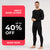 A man standing visible in full height, dressed in black merino wool clothing. There is a banner announcement of 40% off men's base layers.