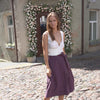 MENIQUE Linen wrap style skirt with tie belt in Shadow Purple color.