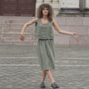 Woman wearing linen outfit. Skirt and blouse in stone green color