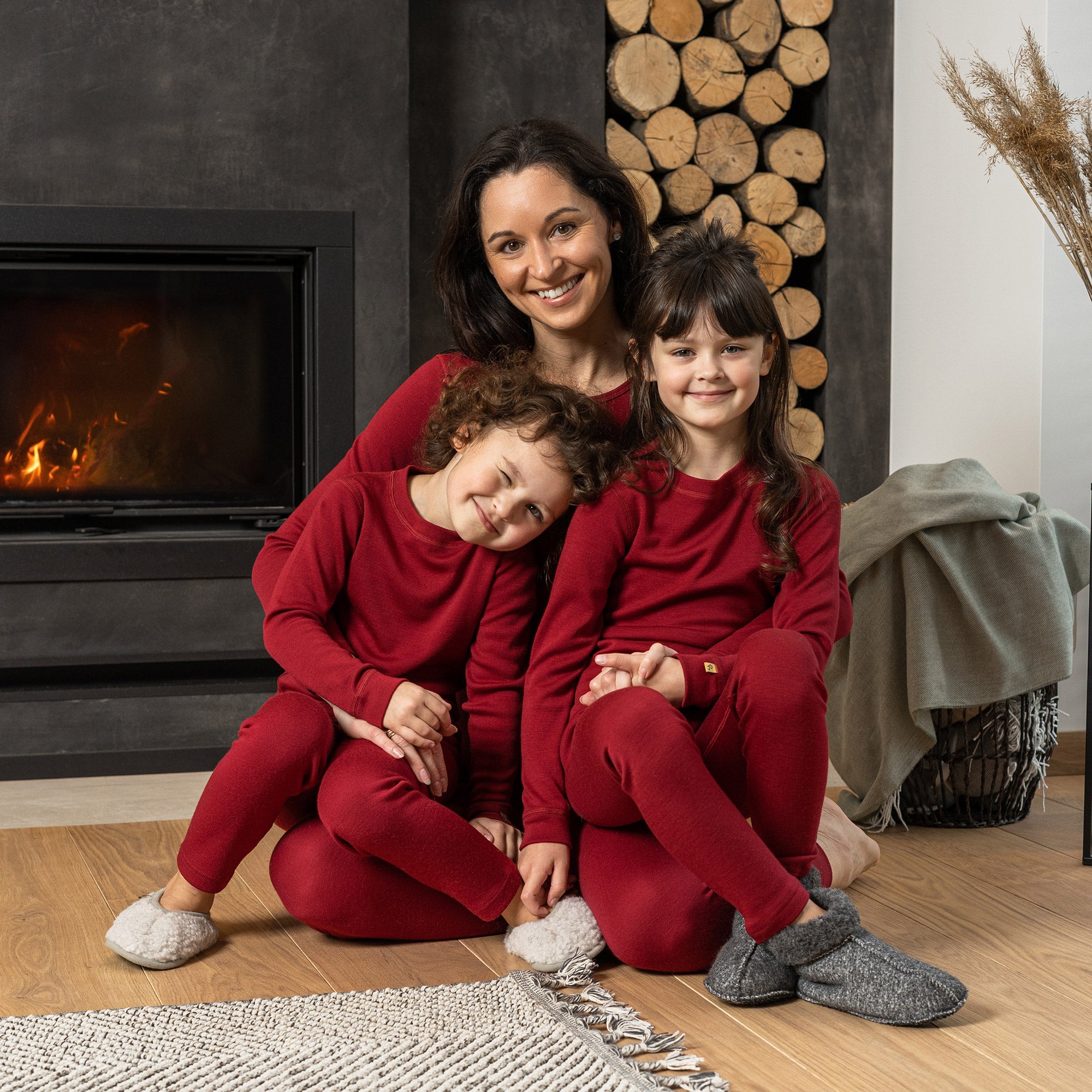 Front view of the kids' menique merino 250gsm long sleeve top, in royal cherry color, white background.